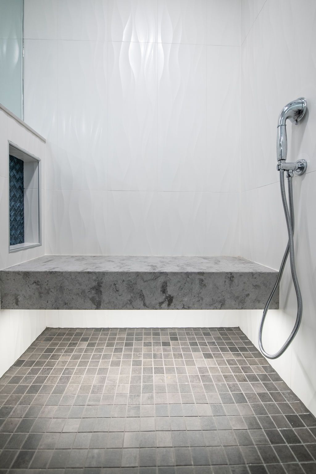 A bathroom with a bathtub and a shower head