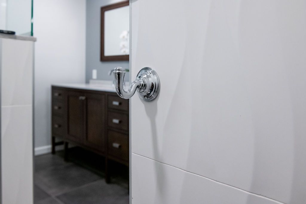 A bathroom with a sink , mirror and shower.