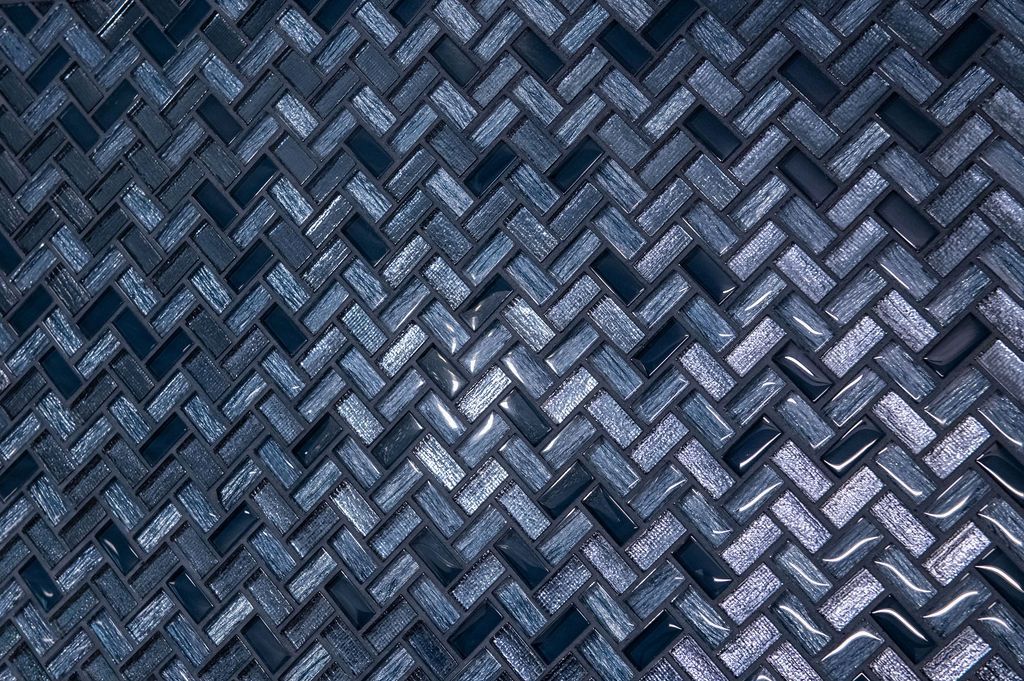 A close up of a blue mosaic tile wall.