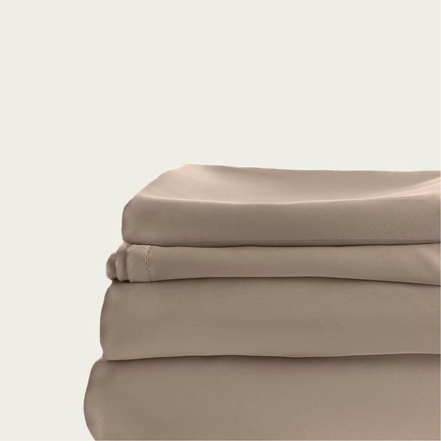 A stack of beige sheets are sitting on top of each other on a white background.