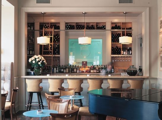 A restaurant with a piano and tables and chairs