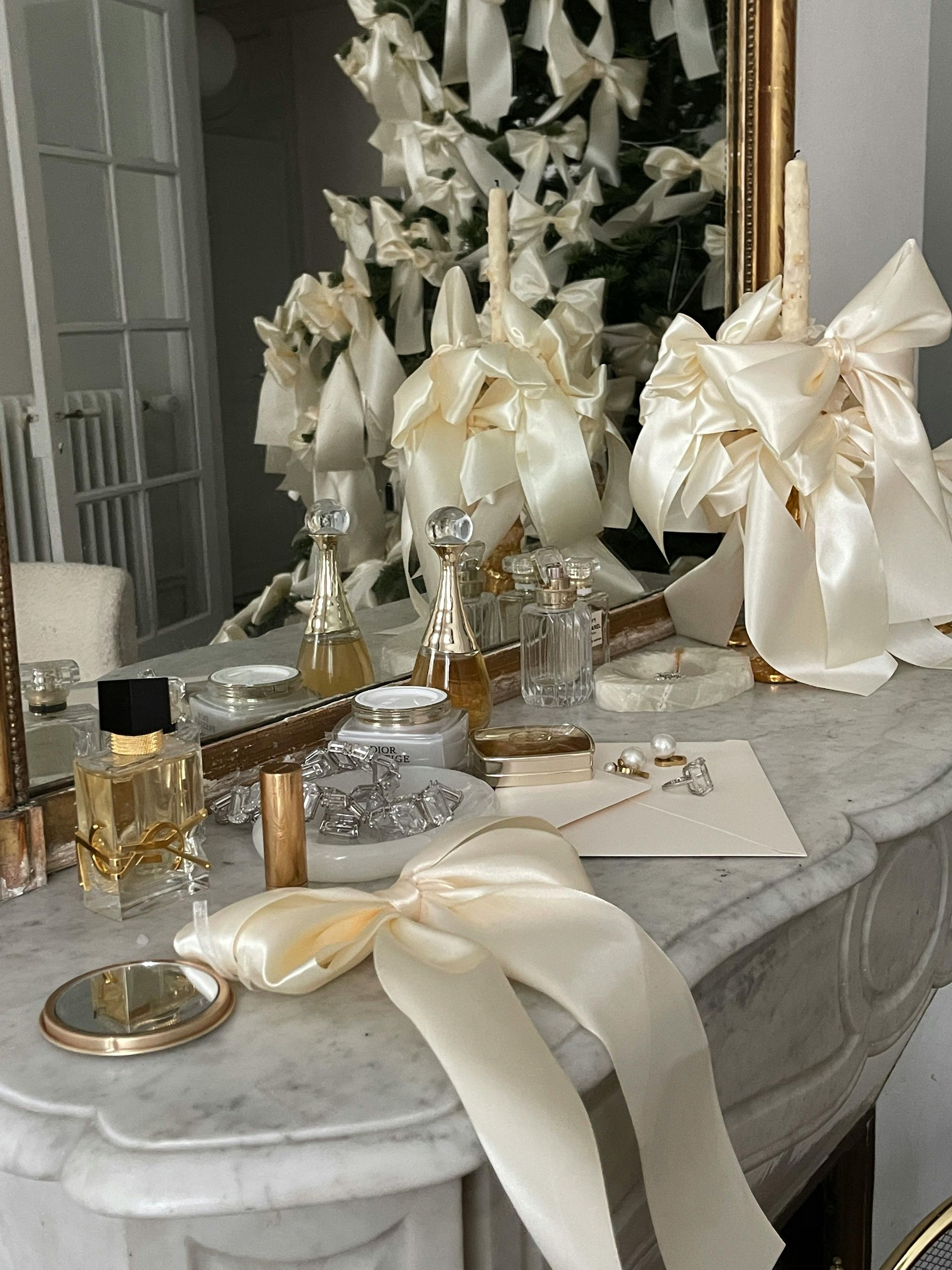 A table with perfume bottles and a mirror on it.