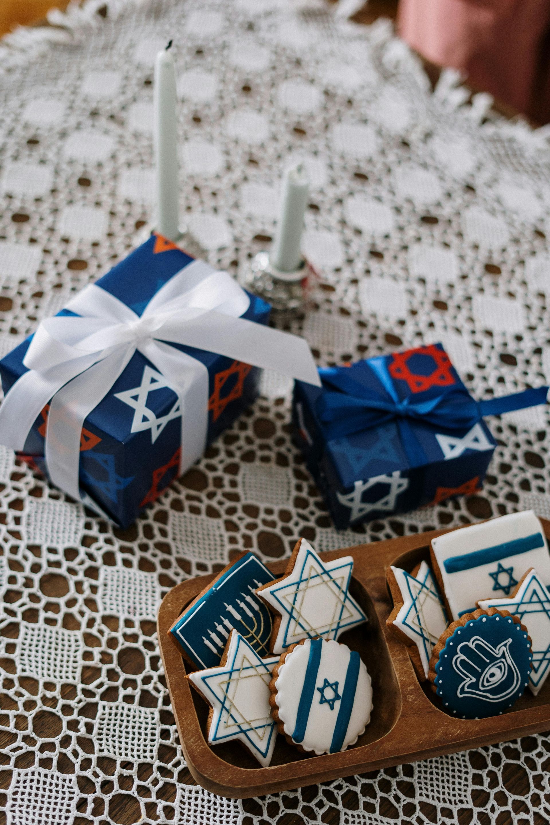 A wooden tray filled with cookies and gifts on a table.