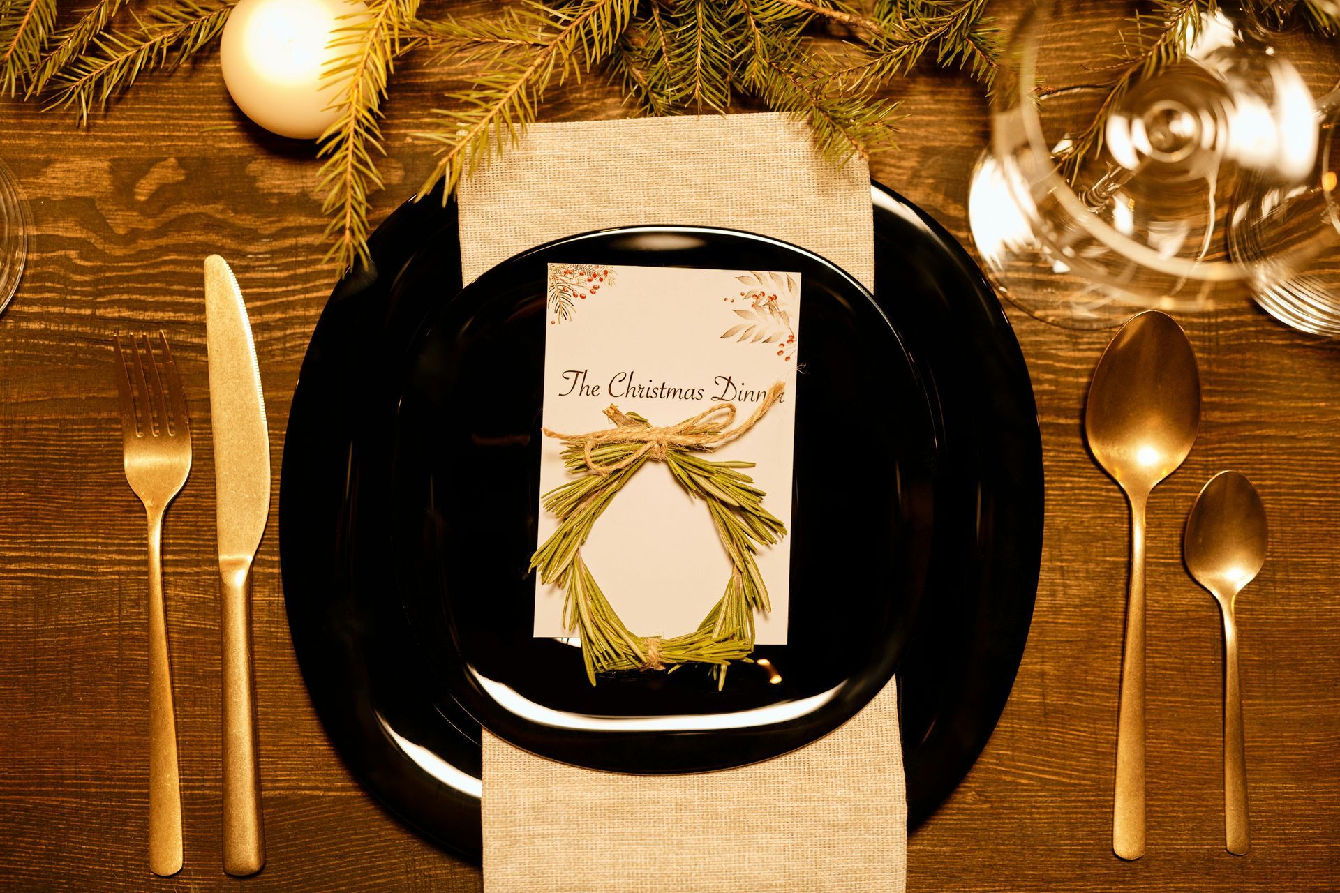 A place setting for a christmas dinner with a place card on a plate.