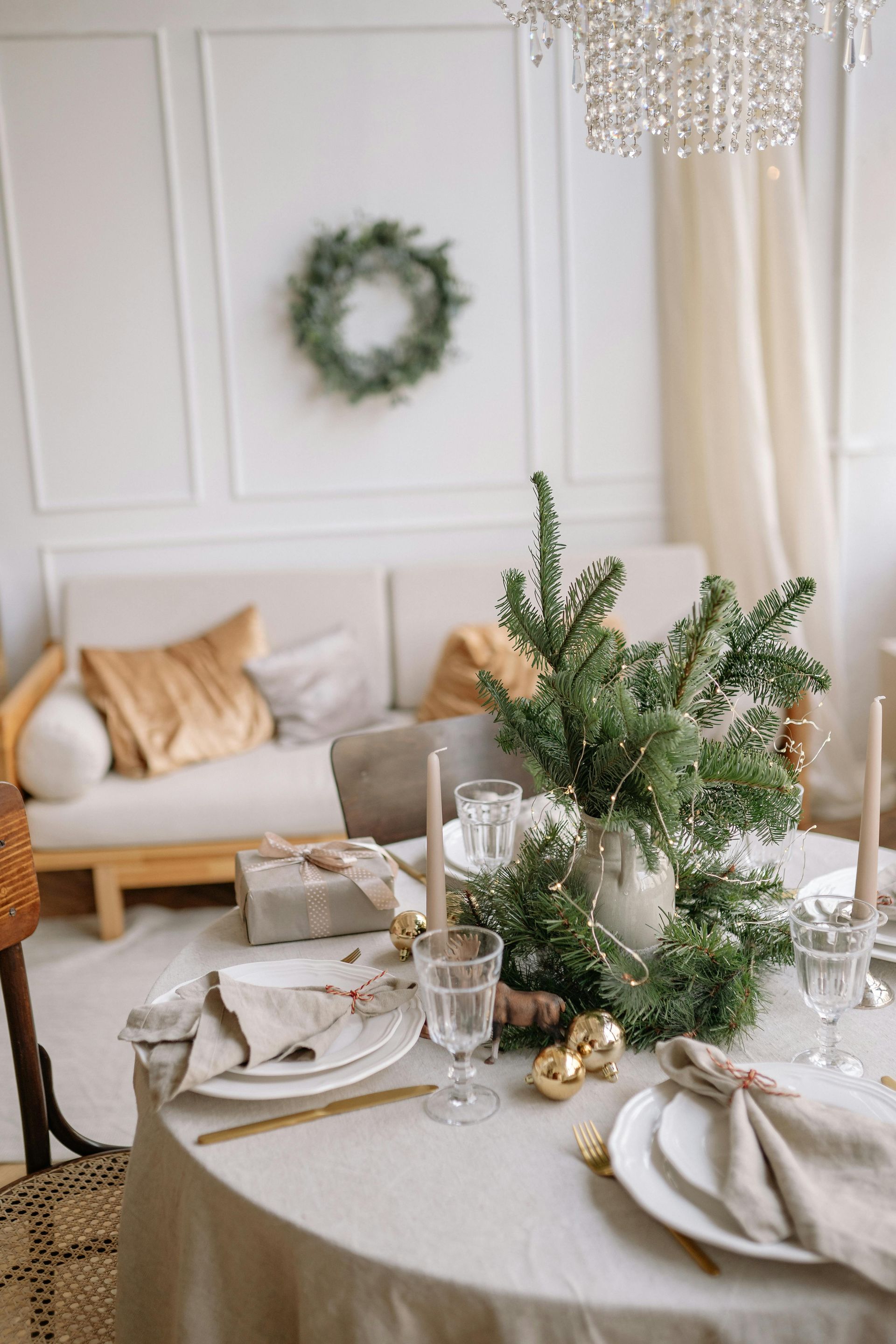 A table set for a christmas dinner in a living room.
