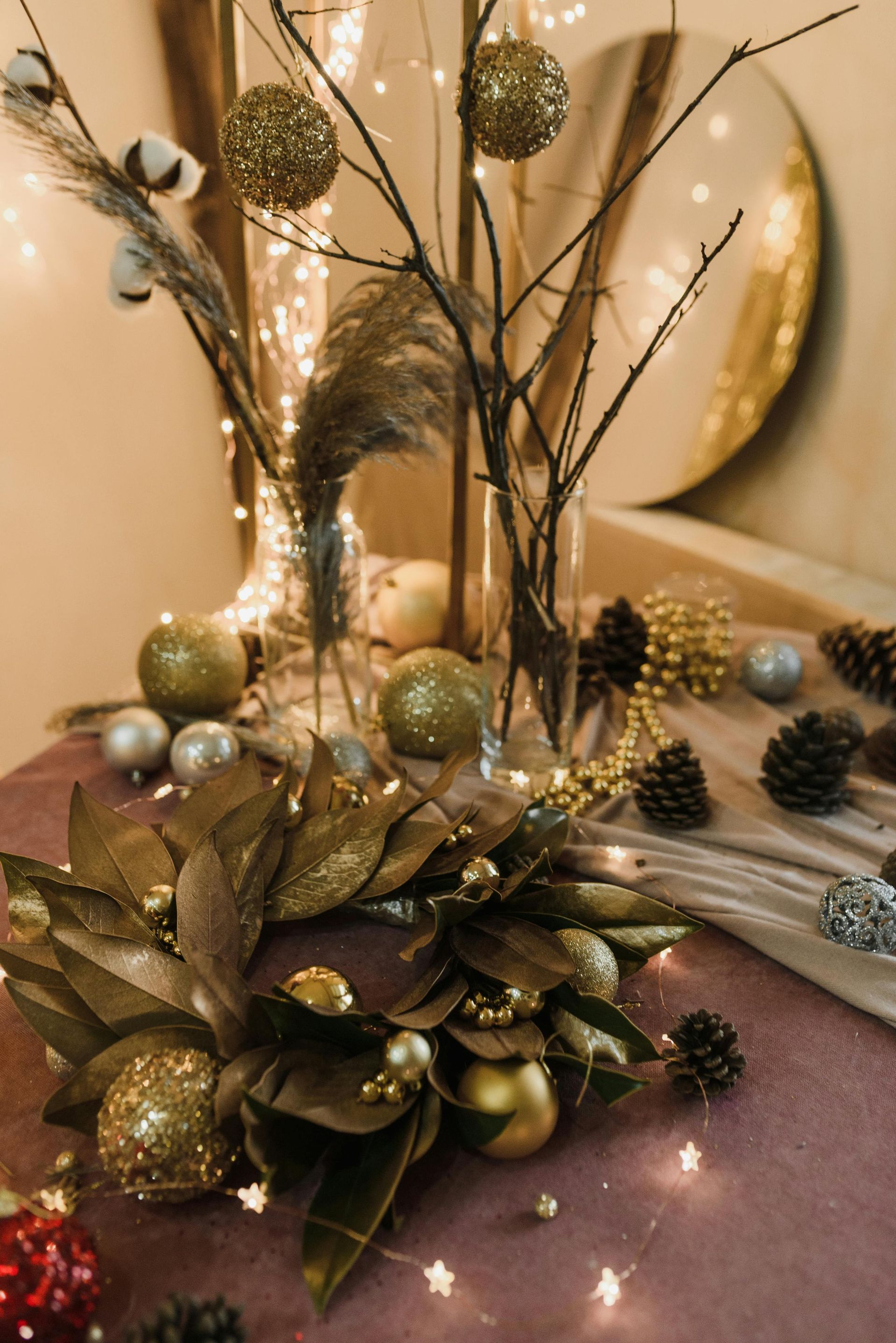 A table is decorated with christmas decorations and a mirror.