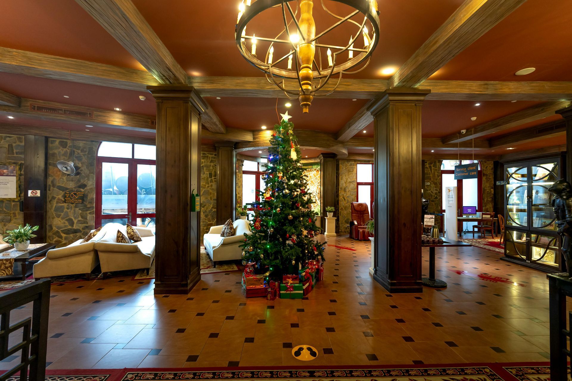 There is a christmas tree in the middle of the room.