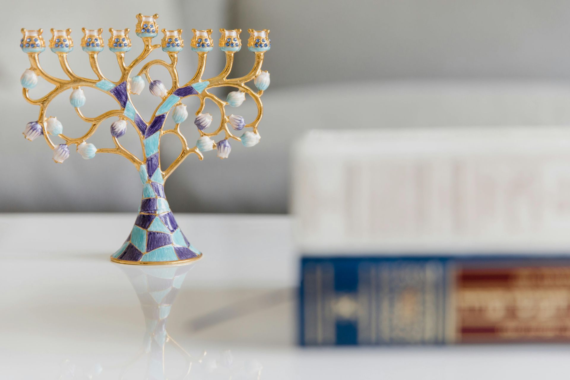 A menorah is sitting on a table next to a book.