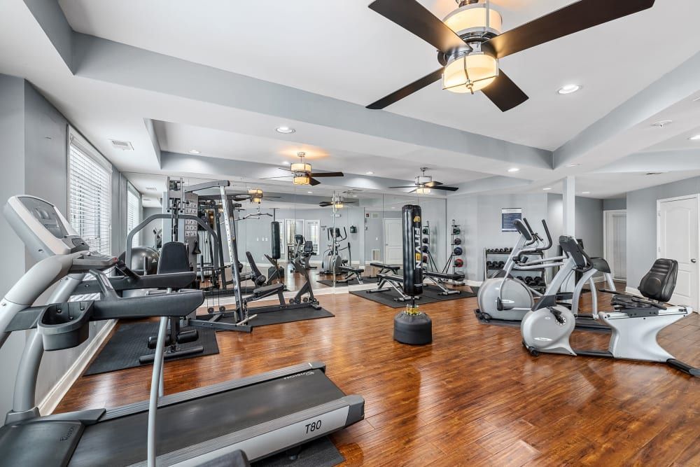 a large gym with a lot of equipment and a ceiling fan at Marquis Midtown West in Atlanta, GA.