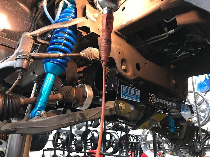 A close up of the underside of a truck with a license plate that says king