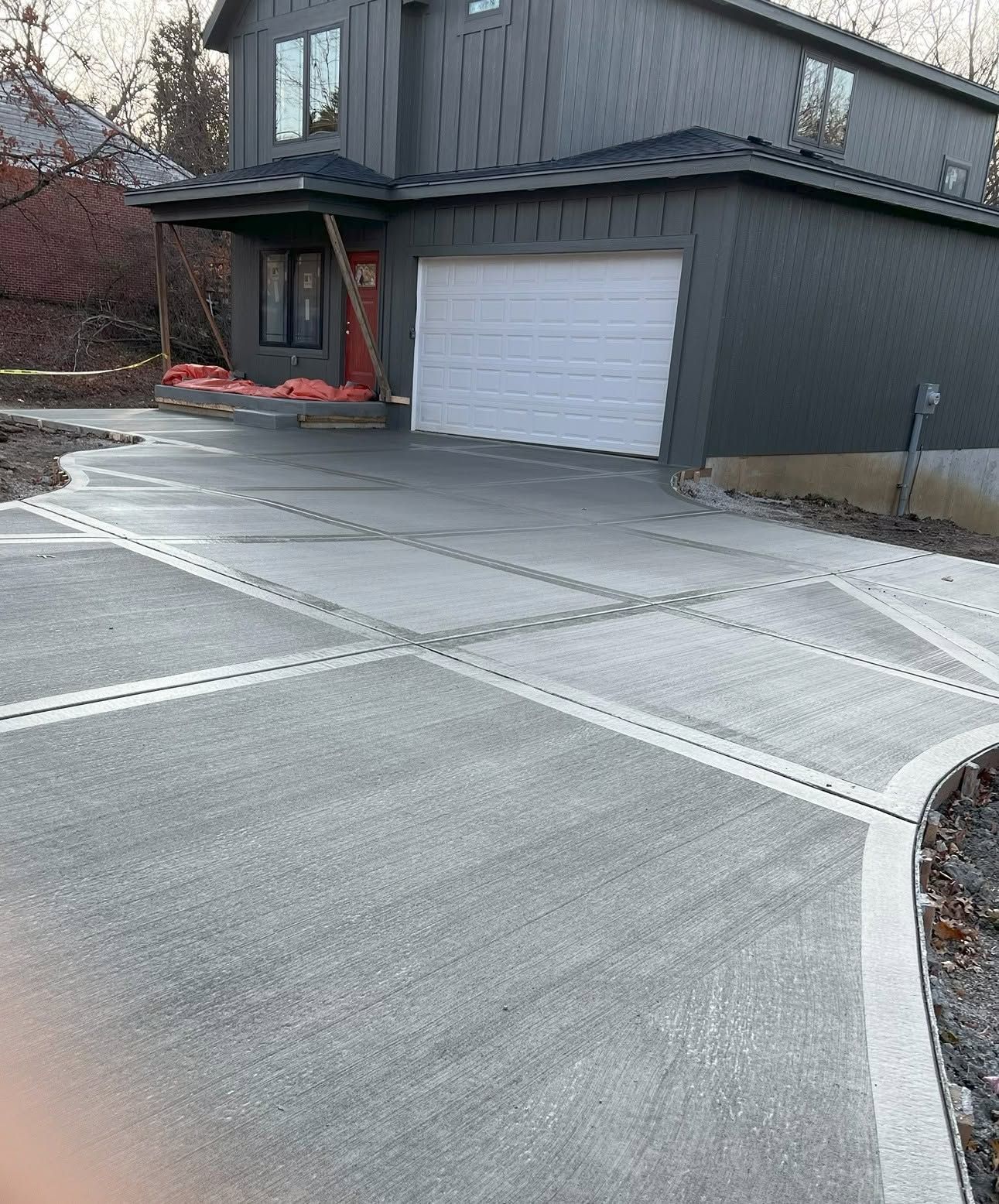 Residential Driveway With Fresh Concrete In Front House And Garage.