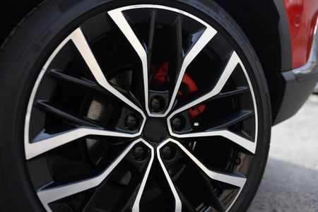 A close up of a car wheel with a black and white rim