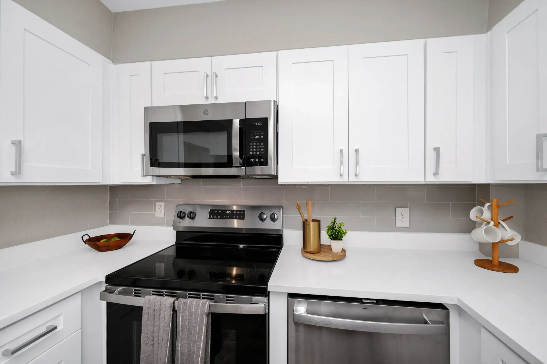White shaker-style cabinets with quartz countertops