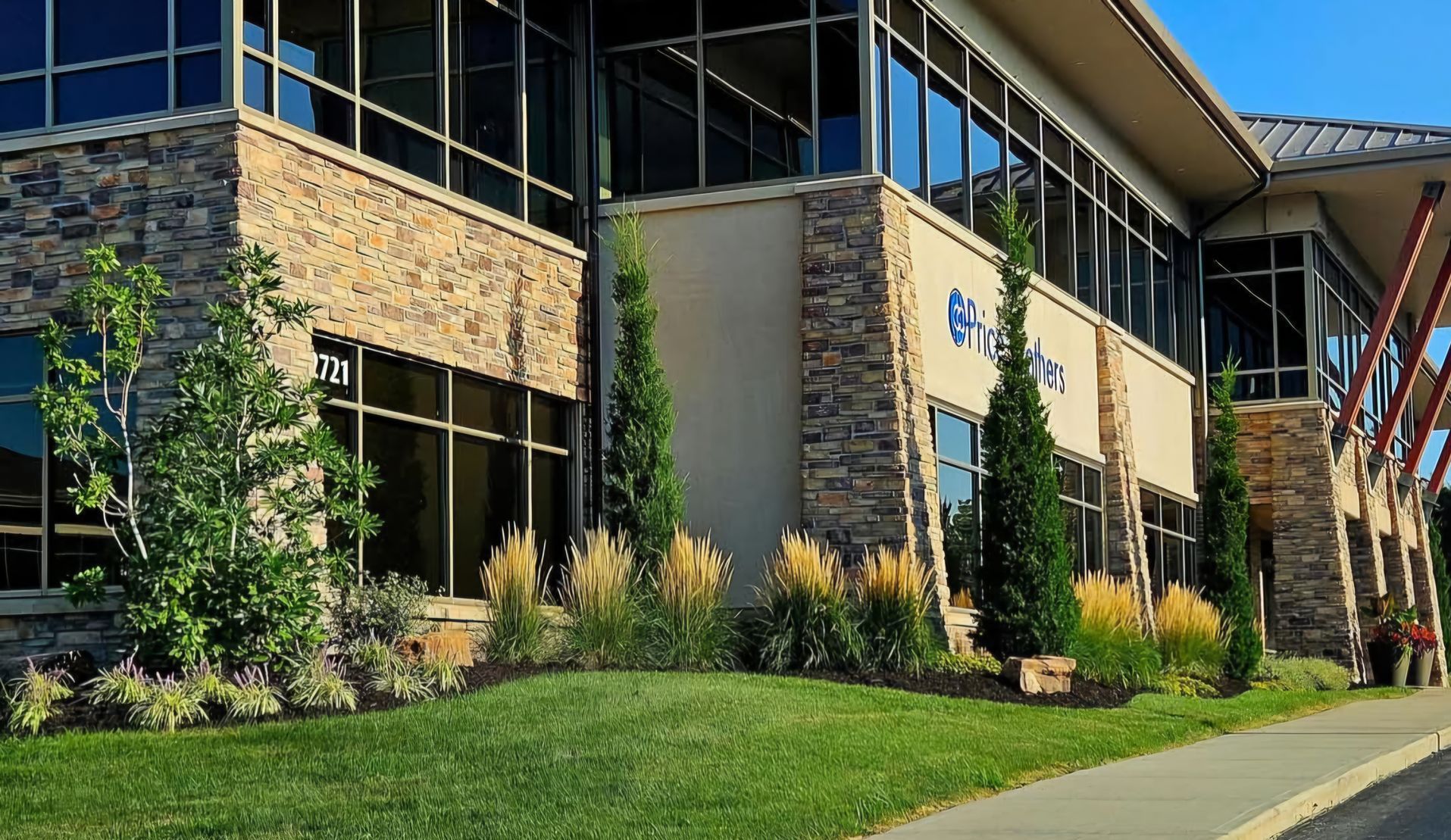 A large building with a lot of windows and trees in front of it.