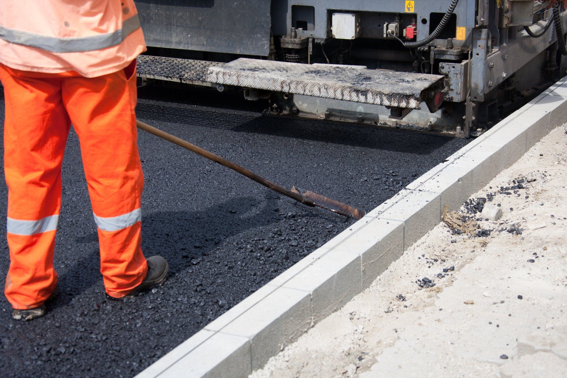 Workers Using Asphalt For Road Repairs — Vacaville, CA — American Asphalt
