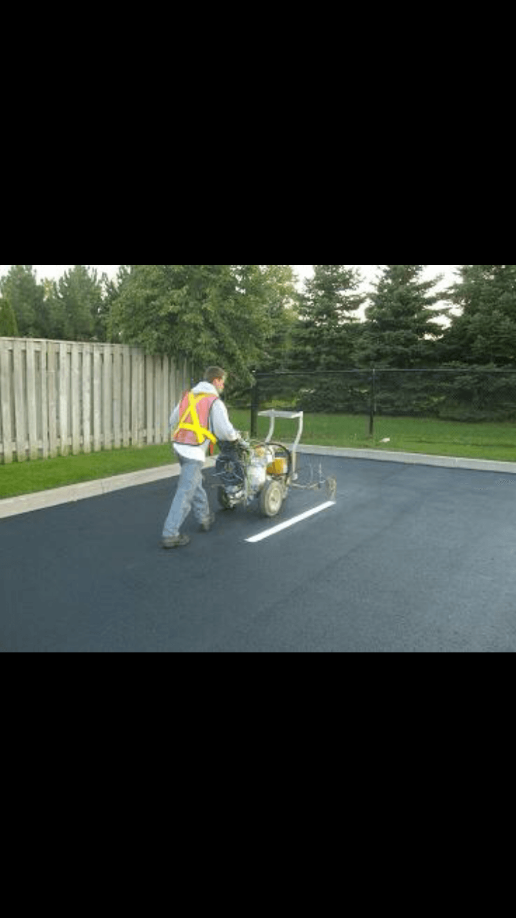 Worker Painting Line — Vacaville, CA — American Asphalt