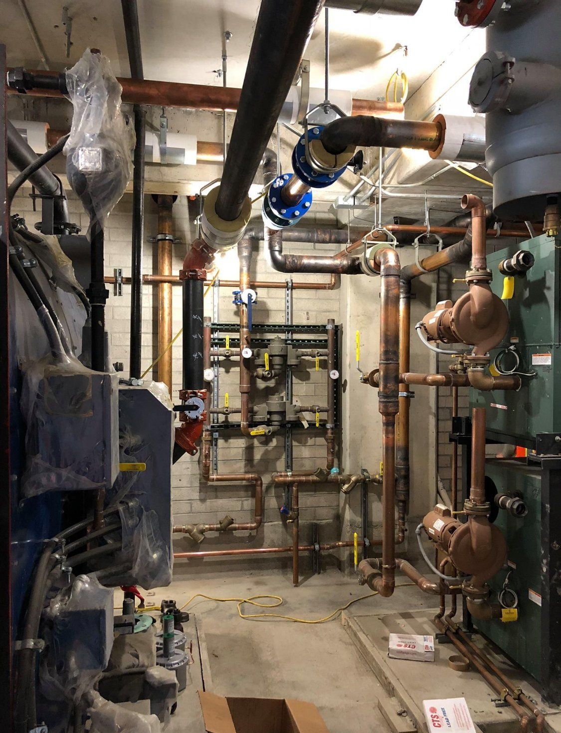 A room with a lot of pipes hanging from the ceiling