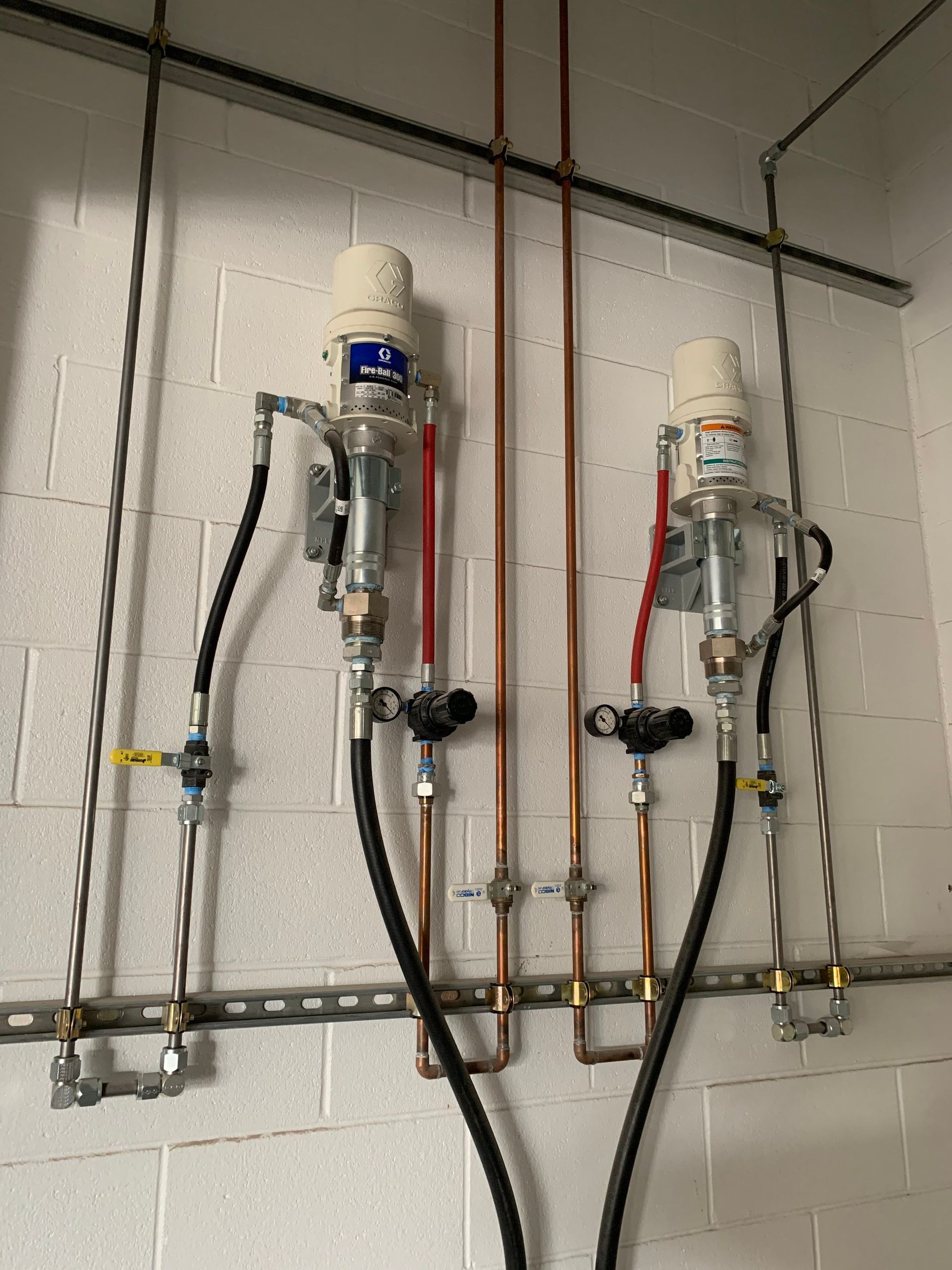 A bunch of pipes are hanging from the ceiling