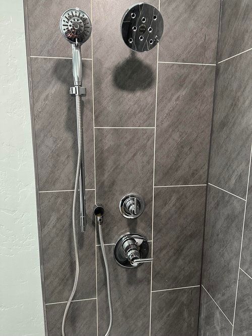 A shower head with a hose attached to it in a bathroom.