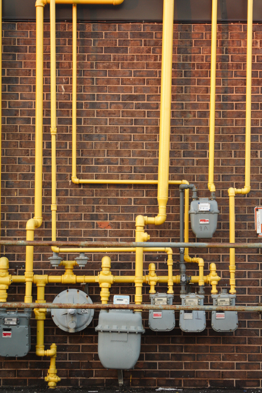Two water heaters are sitting next to each other in a room.