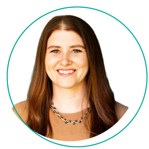 Woman with long brown hair smiles, wearing a necklace and tan shirt, inside a teal circle.