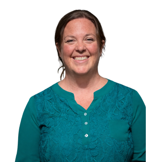 Smiling woman with short blonde hair, wearing a blue-green shirt and layered necklace, outdoors.