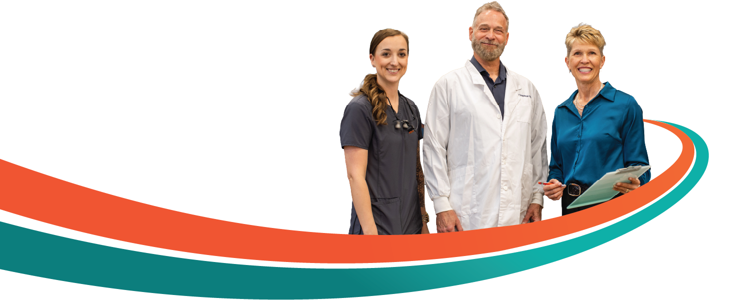 Three people, a man in a lab coat holding a clipboard, and two women, smiling, stand near a curved orange and teal line.