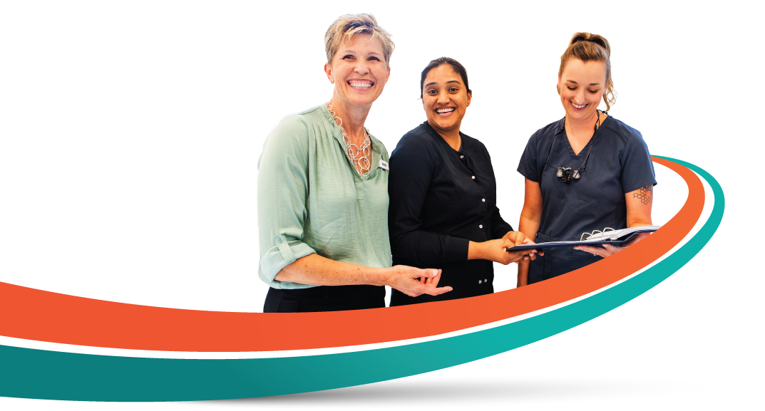 Three people, a man in a lab coat holding a clipboard, and two women, smiling, stand near a curved orange and teal line.