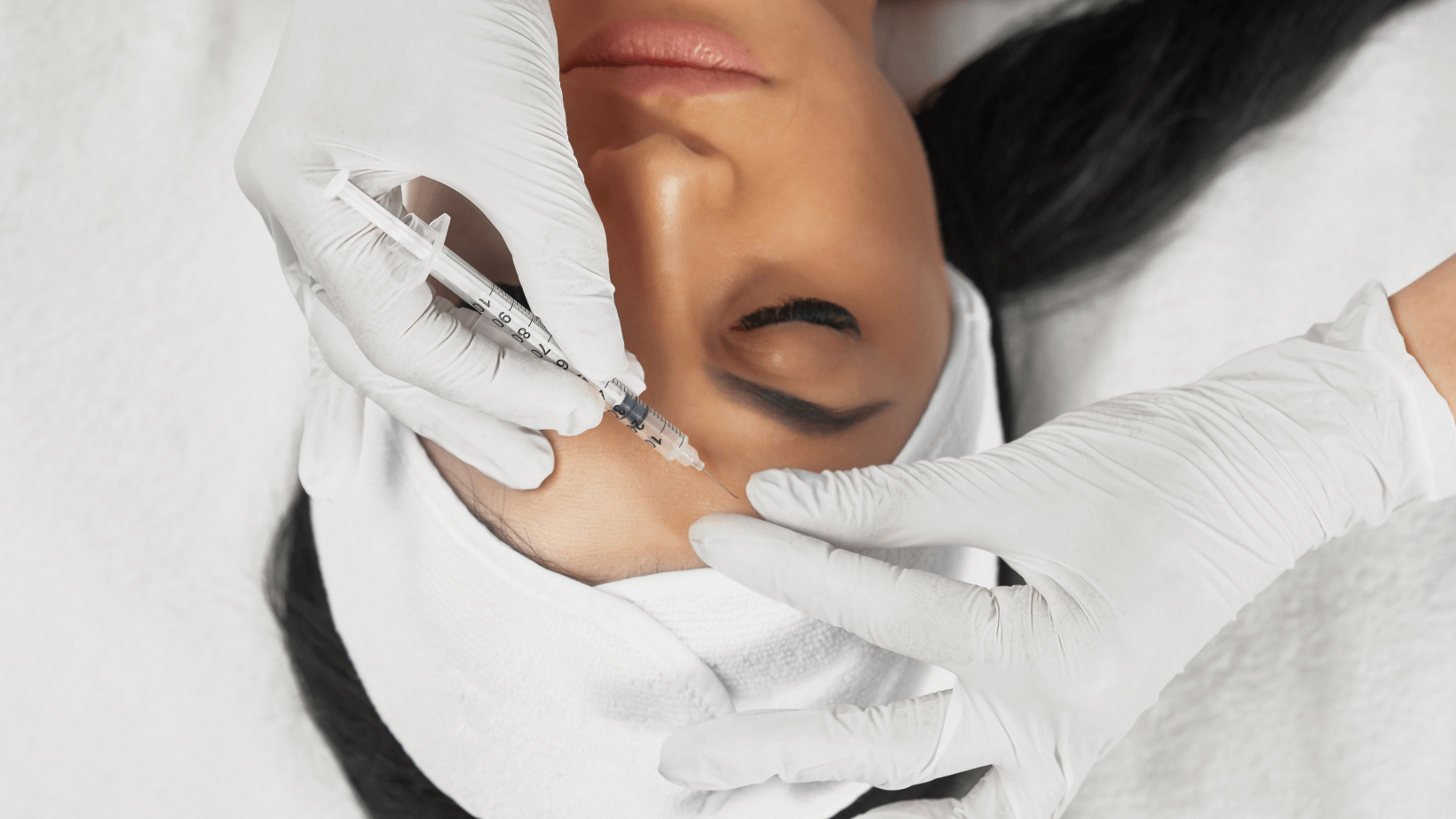 A Woman Is Getting a Botox Injection in Her Face