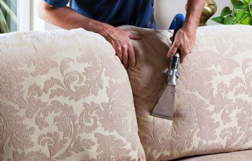 Man steam cleaning the upholstery