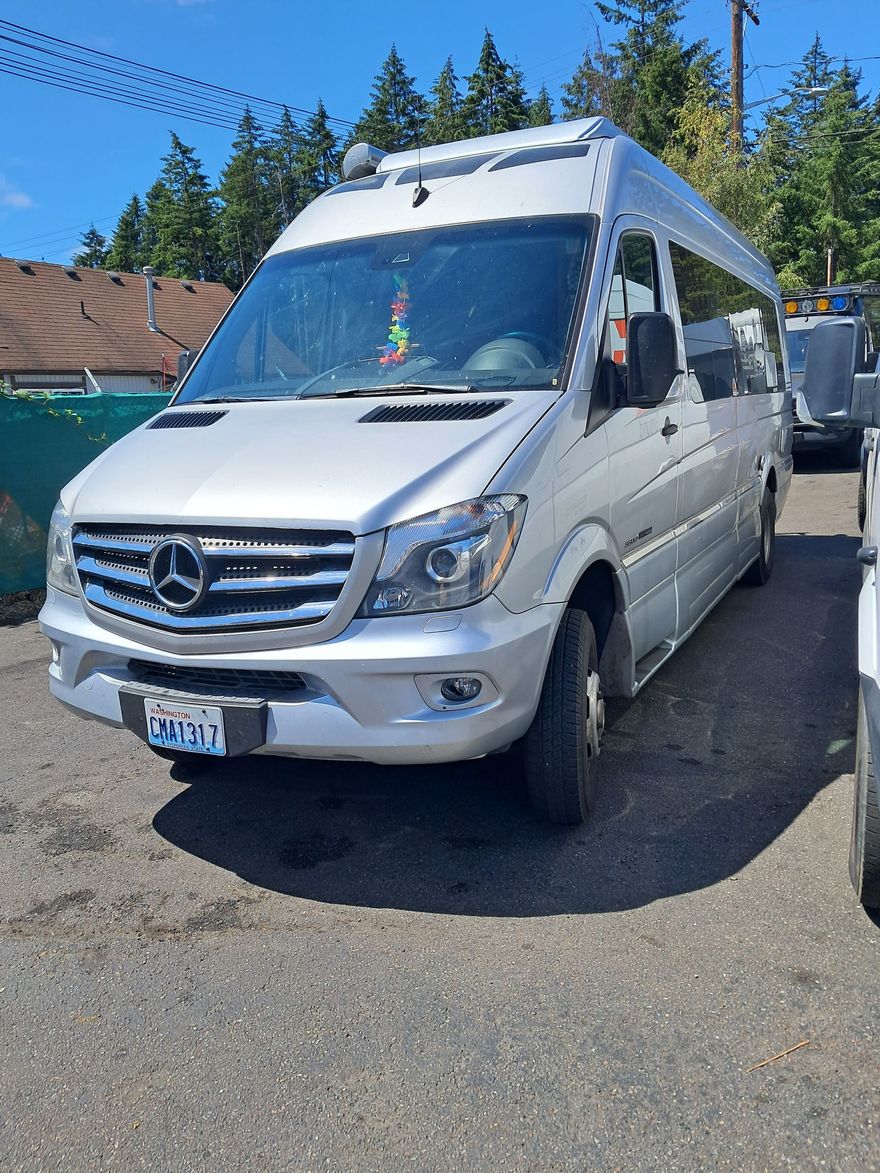 A silver van is parked |  The Sprinter Shop, Inc.