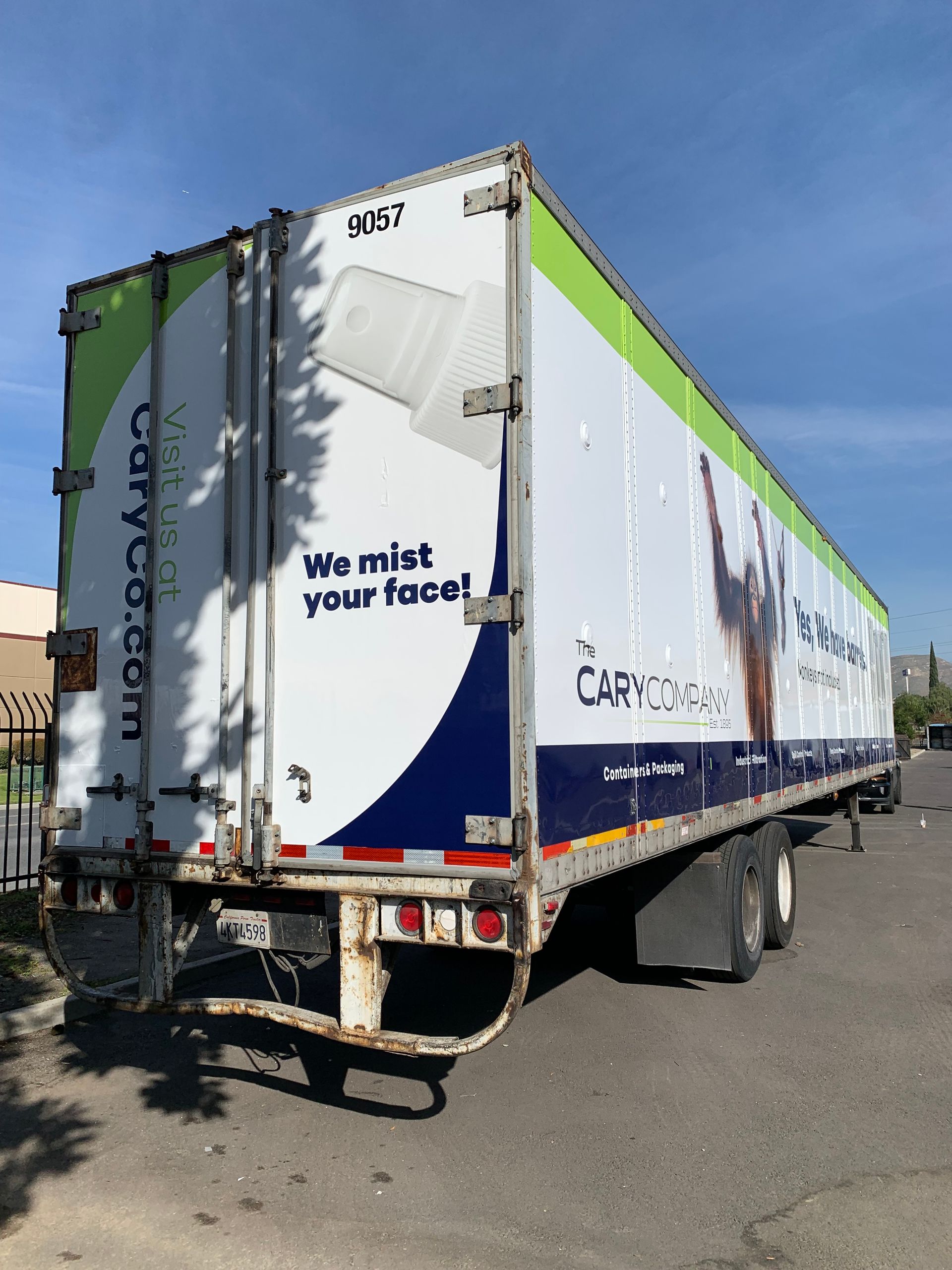 White semi-trailer with green and blue graphics; 