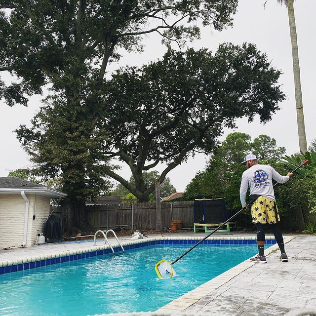 Man Removing Dirt on the Pool — New Orleans, LA — Blue Street Pools
