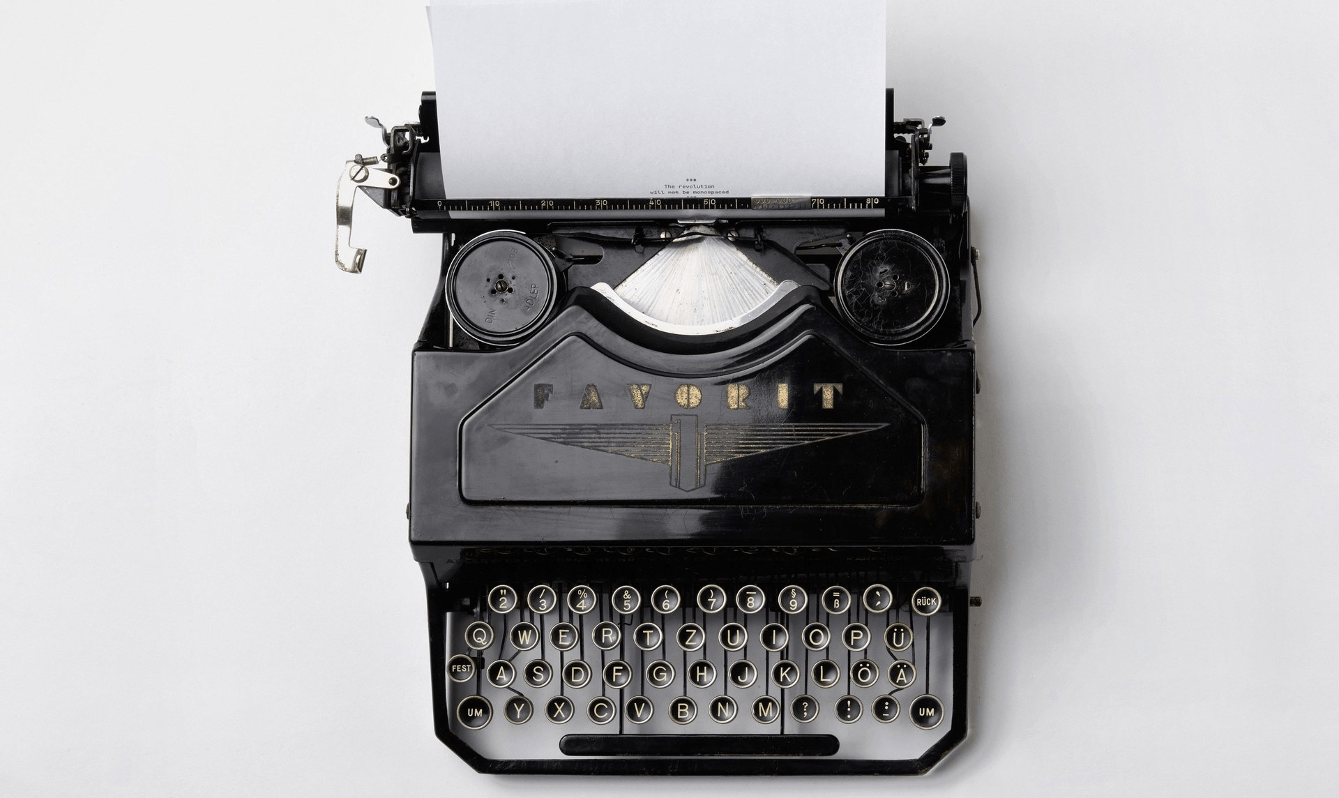 An old typewriter with a piece of paper coming out of it.