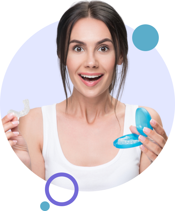 Woman holding an Invisalign clear aligner in one hand and another clear aligner in case in the other hand