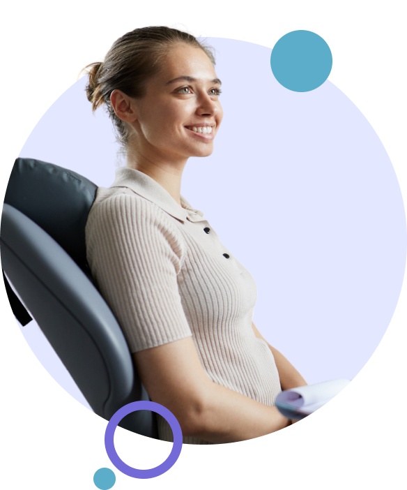 Woman smiling while smiling in a dental chair