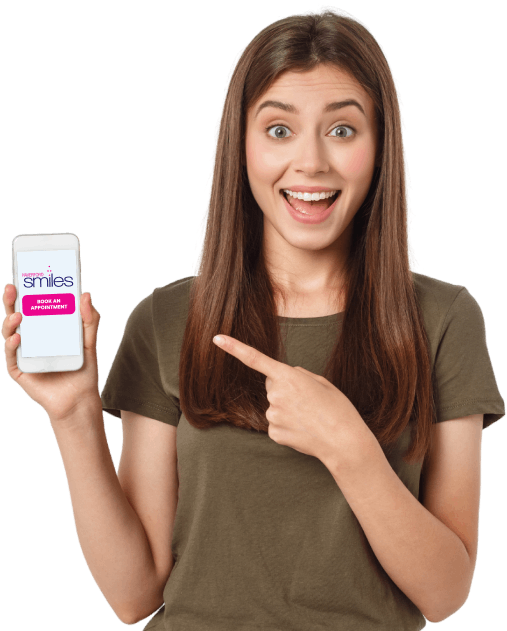 Woman smiling while point to her mobile phone that has Haverford Smiles website showing