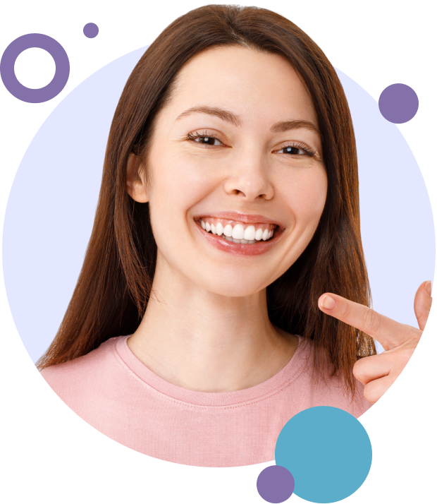 Smiling woman pointing to her tooth that has a crown