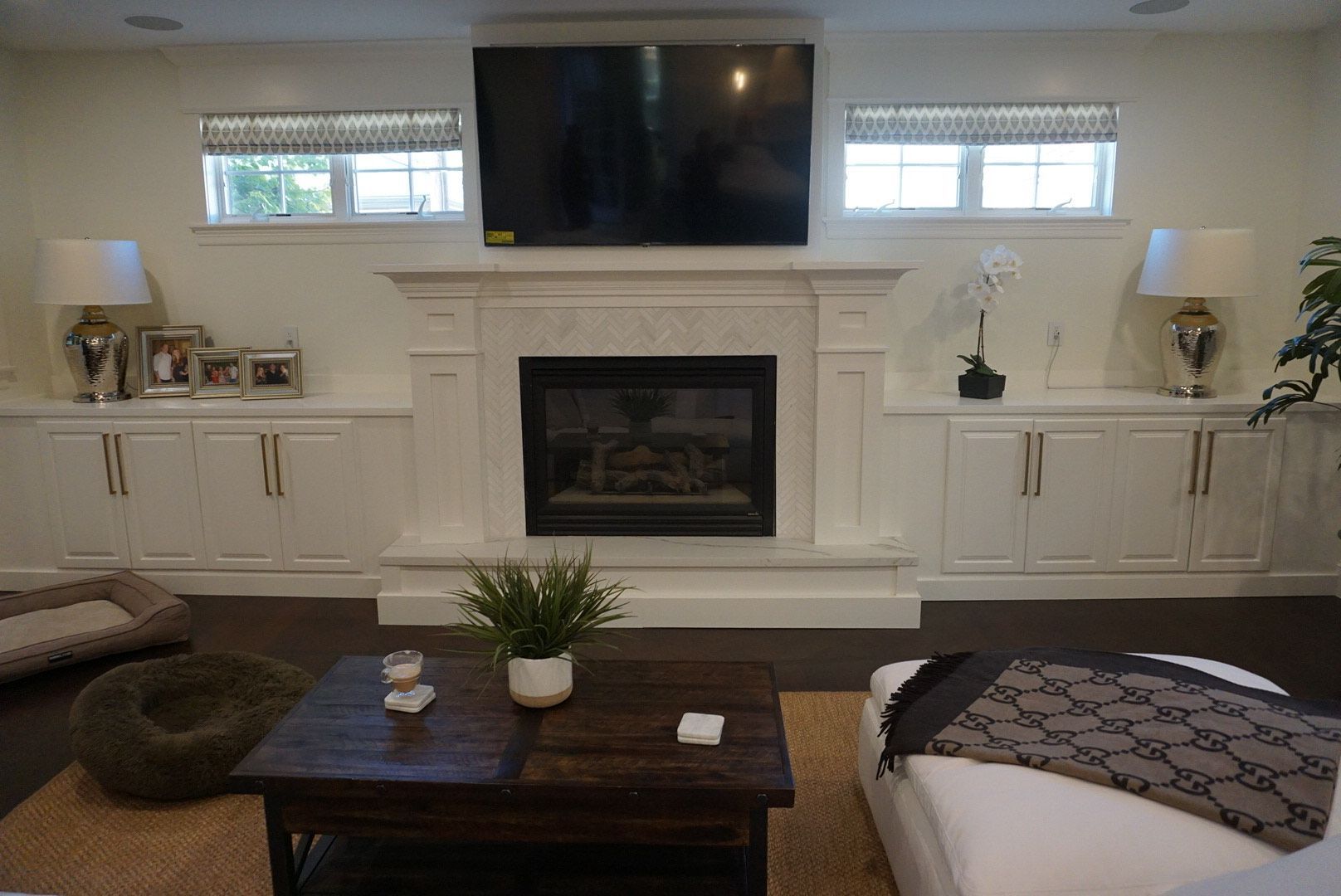 A living room with a fireplace and a flat screen tv.