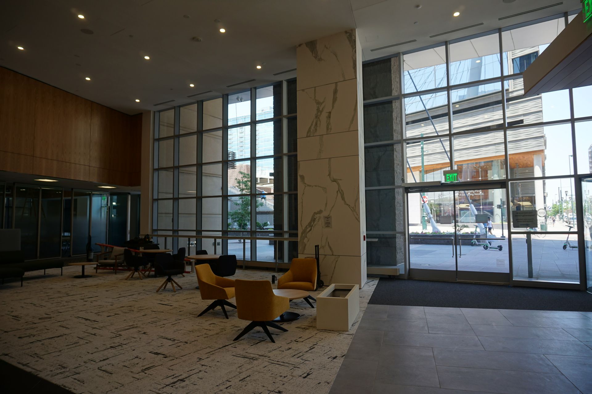 A large lobby with a lot of windows and chairs.