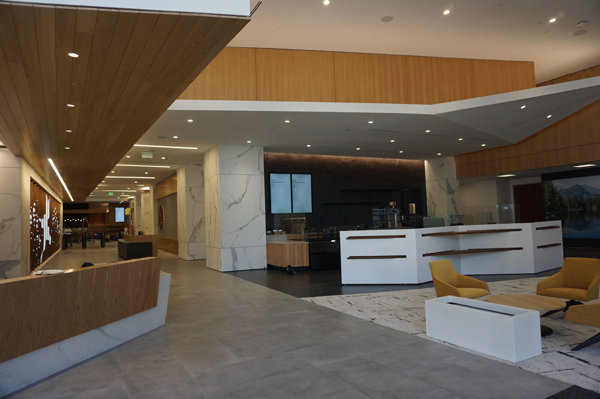 A large lobby with a reception desk and chairs