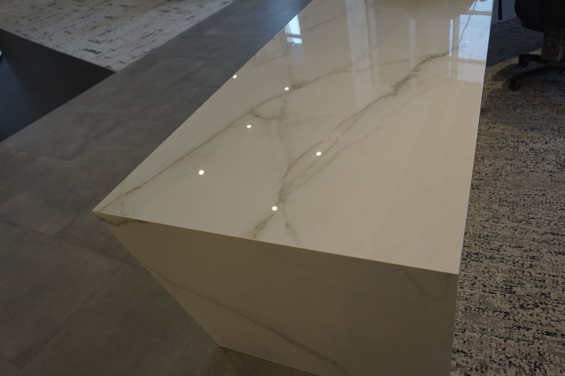 A close up of a white marble counter top in a living room.