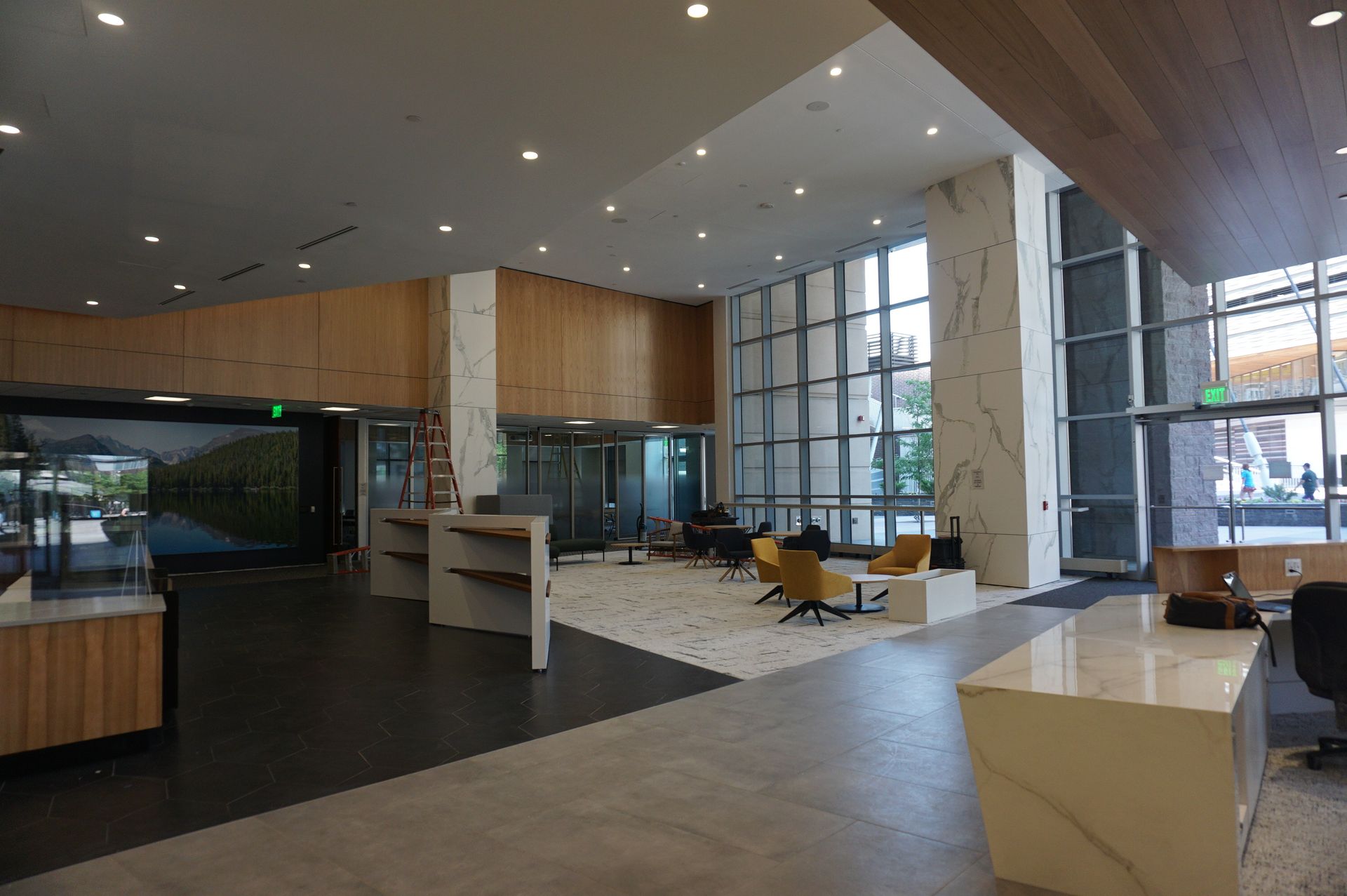A large lobby with a lot of windows and furniture in a building.