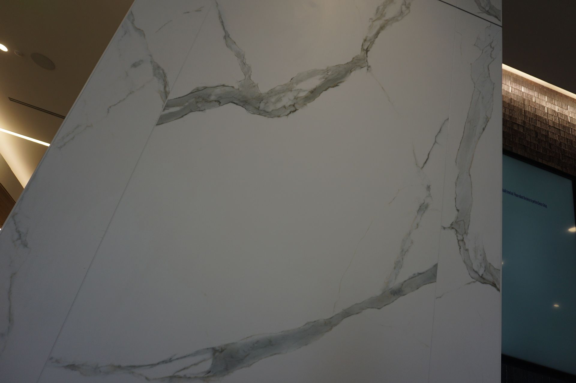 A close up of a white marble wall in a room