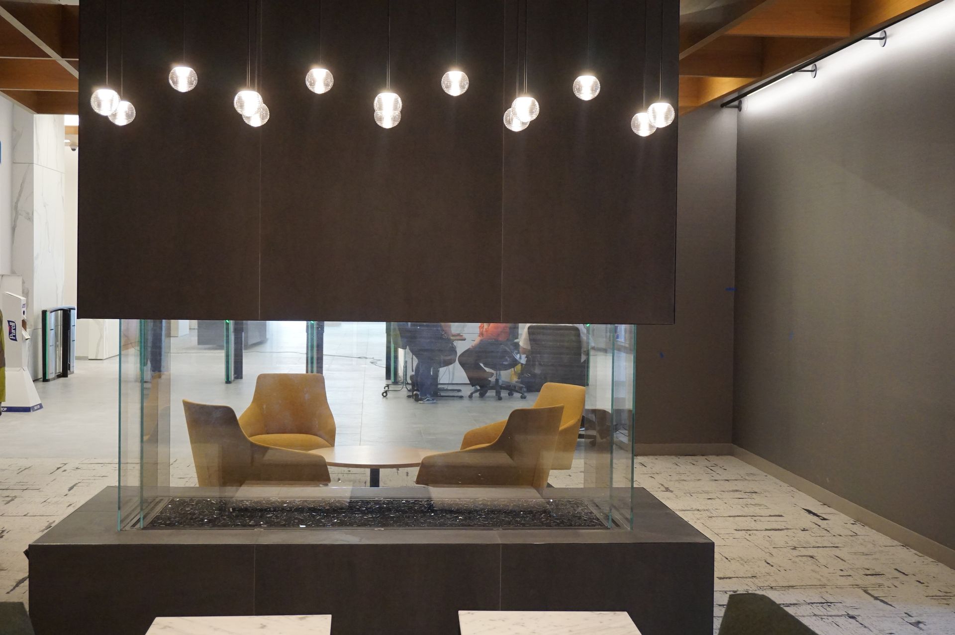 A room with a fireplace and chairs in it