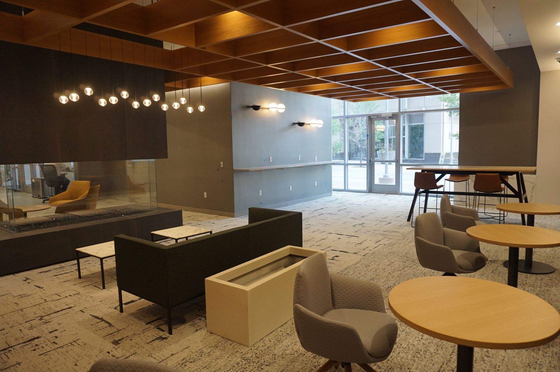 A living room with a couch , chairs , tables and a fireplace.