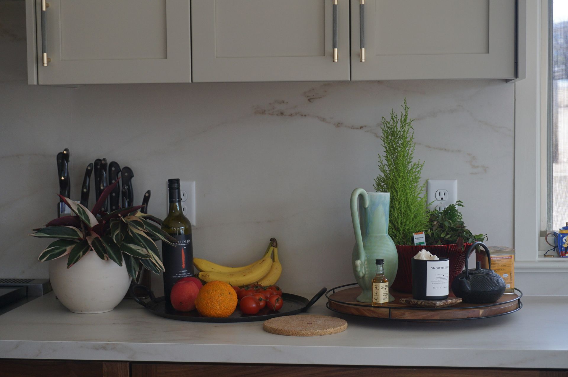 A kitchen counter with a variety of fruits and vegetables on it