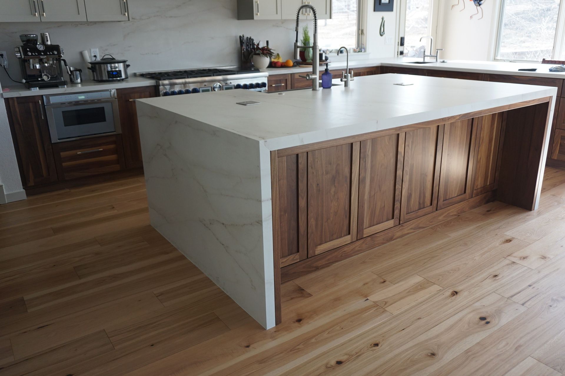A kitchen with a large island and wooden cabinets