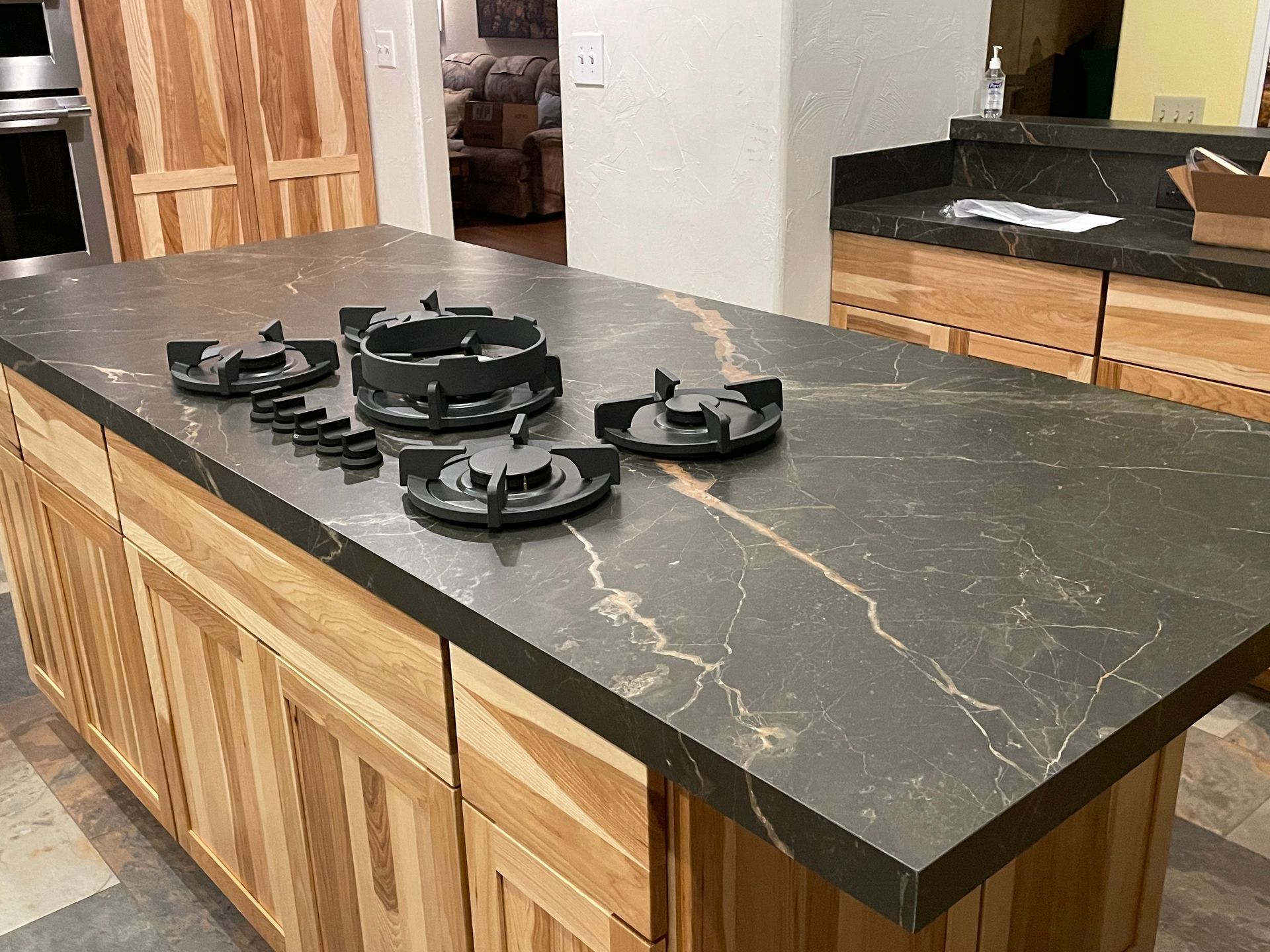A kitchen island with a stove top oven on top of it.