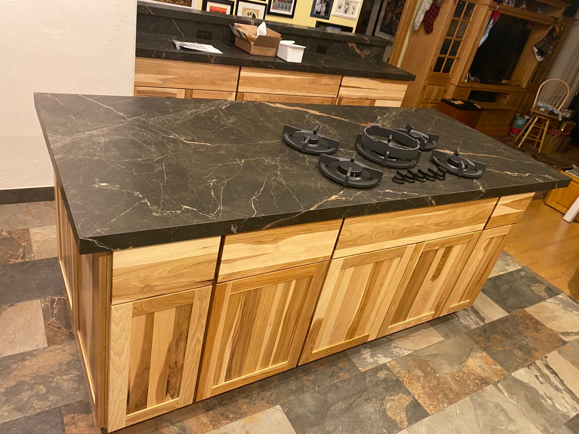 A kitchen island with a stove top oven on top of it.